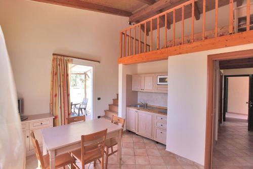 a kitchen and dining room with a table and chairs at Il Villaggio Di Giuele in Finale Ligure