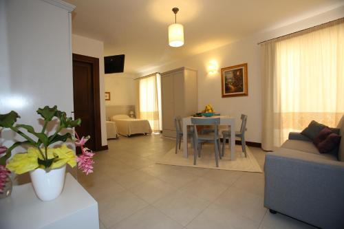 a living room with a couch and a table at Albergo Residenziale La Corte in Tortolì