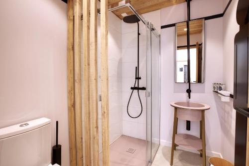 a bathroom with a shower and a toilet and a sink at Les Clés du Clos in Brides-les-Bains