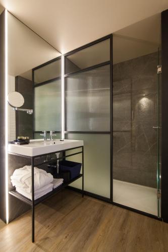 a bathroom with a sink and a shower at Pestana Collection Plaza Mayor in Madrid