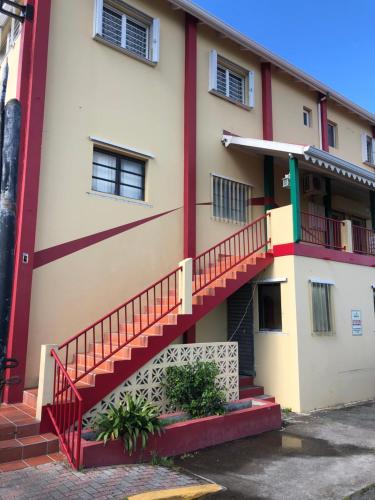 a building with a staircase on the side of it at Carl's Unique Inn & Conference Facilities in Simpson Bay