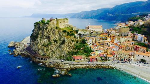 an aerial view of a town on a rocky island in the water at Scilla Resort in Scilla
