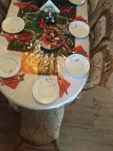 a table with plates of food on top of it at Pensiunea Valea Branzei in Năneşti
