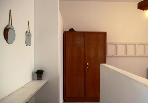 a hallway with a wooden door in a room at PLAN SEA Guest House in Santa Margherita Ligure
