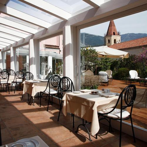 a restaurant with tables and chairs on a patio at La Locanda Delle Donne Monache in Maratea