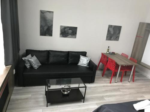 a living room with a black couch and a table at Old Town Boutique Apartments in Liberec