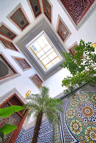 a room with a ceiling with a palm tree in it at Dar Abdesalam in Fès