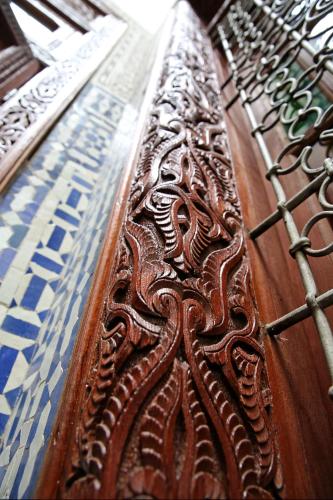 a close up of a wooden table with patterns on it at Dar Abdesalam in Fès