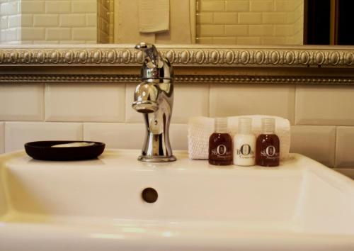 a bathroom sink with a faucet and two cups at PLAN SEA Guest House in Santa Margherita Ligure