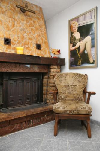 a chair sitting in front of a fireplace at Villa Marija in Trogir