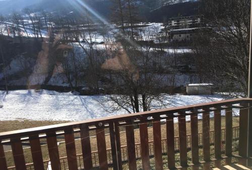 a view of a snow covered yard from a balcony at Appartamento Limone con vista in Limone Piemonte