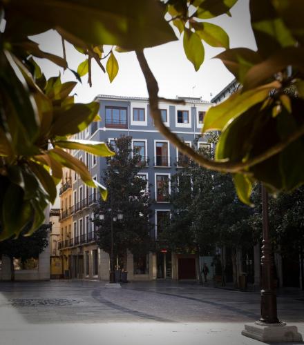 an empty street in front of a building at Nest Style Granada in Granada