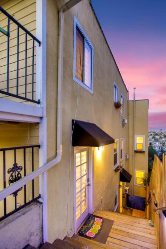 a building with a porch with a door and a balcony at Casa Pacifica - BBQ, Firepit, Walk to tons of fun places in San Diego