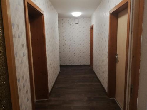 a hallway of an empty room with two doors at Apart Family Schweng in Tux