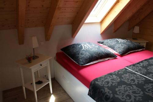 a bedroom with a bed and a table and a window at Der Kolonist in Burg