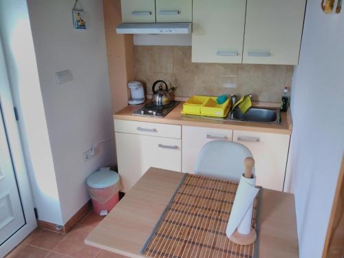 a small kitchen with a sink and a table at Apartments Bogunovic in Ploče