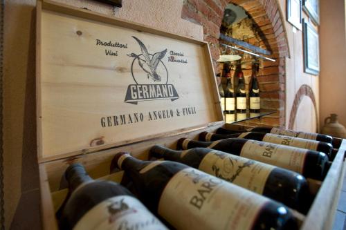 a row of wine bottles in a wine cellar at Casa Svizzera Agriturismo in Barolo