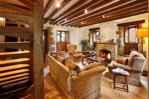 a living room with couches and a fireplace at Aslan in Chipping Norton