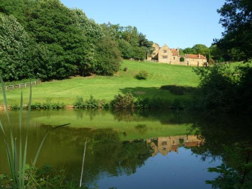 a view of a lake with a castle in the background at Aslan in Chipping Norton