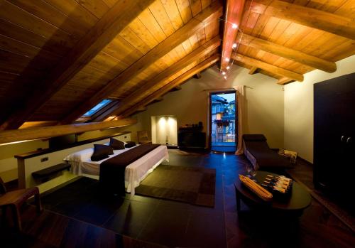 a large room with a bed and a couch at Casa Svizzera Agriturismo in Barolo