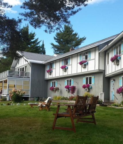 a building with benches in front of it at Carlson's Lodge in Twin Mountain