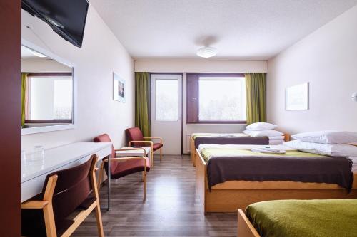 Säng eller sängar i ett rum på Hotelli Pielinen
