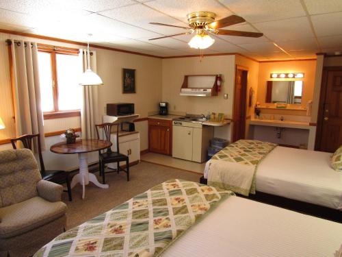 a hotel room with two beds and a kitchen at Carlson's Lodge in Twin Mountain