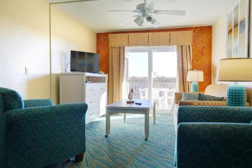 a living room with a couch and a table at Ocean Pines Resort in Duck