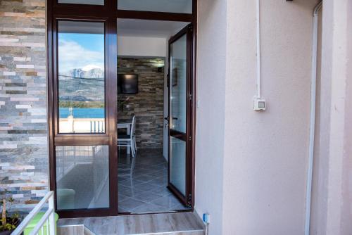 a glass door leading to a balcony with a view at Apartments Klakor PS in Tivat