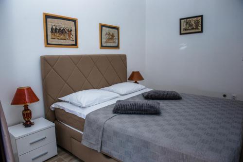 a bedroom with a bed with two pillows on it at Apartments Klakor PS in Tivat