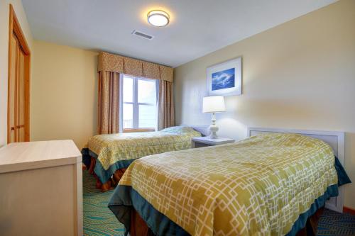 a hotel room with two beds and a window at Ocean Pines Resort in Duck