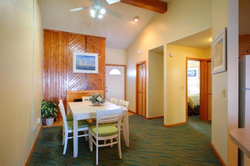 a dining room with a white table and chairs at Ocean Pines Resort in Duck