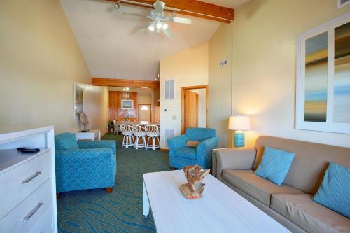 a living room with a couch and chairs and a table at Ocean Pines Resort in Duck