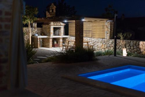 a house with a swimming pool at night at Villa Nathalie - Linardici, Krk in Linardići