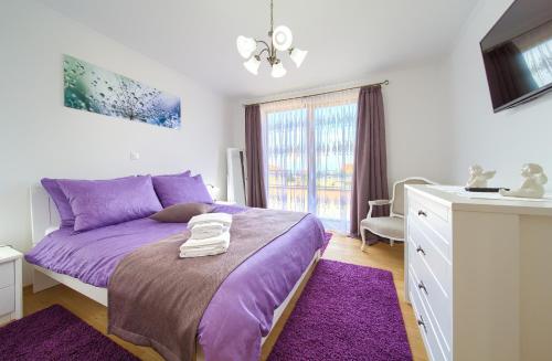a bedroom with a purple bed and a sink at Villa Nathalie - Linardici, Krk in Linardići