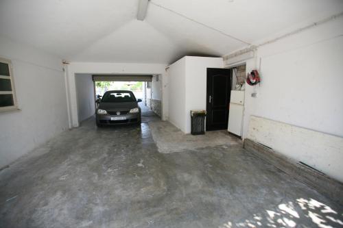 an empty garage with a car parked in it at Villa Marija in Trogir