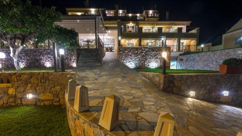 a stone walkway in front of a building at night at Ilia Mare in Ilia