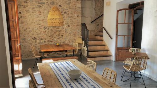 a room with a table and chairs and a staircase at Vista de la Vila - Turismo de interior. in Llubí