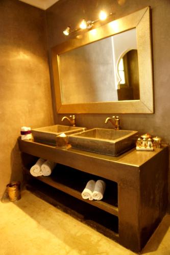 a bathroom with a sink and a mirror at Riad Shama Suites & Spa in Marrakech