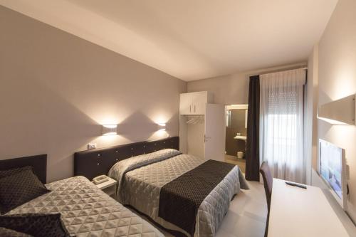 Cama o camas de una habitación en Hotel Delta