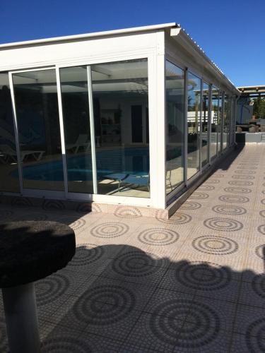 a pavilion with glass doors on a patio at Casa do Campo in Cedros