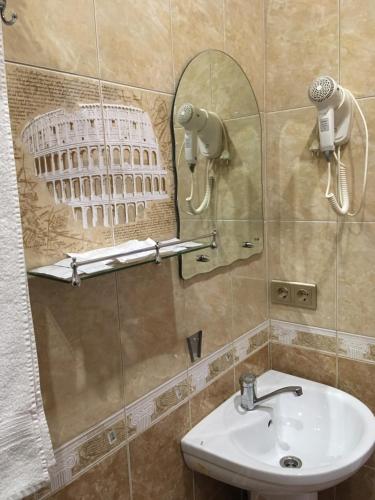 ピャチゴルスクにあるGuesthouse Prestigeのバスルーム(洗面台、鏡、大聖堂付)