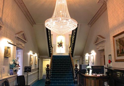 a large stairway leading to a large room at The Tower Hotel in Harwich