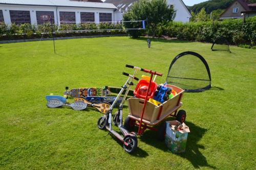 a childs tricycle parked on the grass in a yard at Urlaubsdomizil InselLust-Rügen in Sassnitz