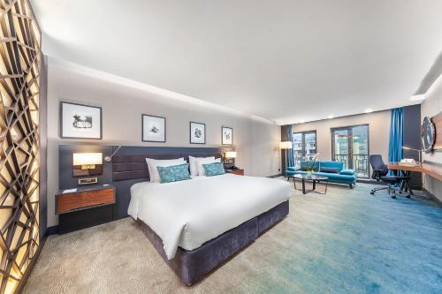 a bedroom with a large bed and a living room at Park Dedeman Trabzon in Trabzon