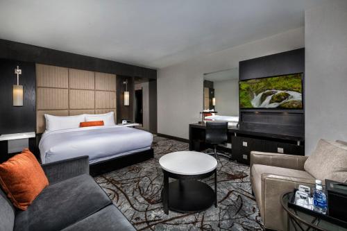 a hotel room with a bed and a couch at The Hotel at the University of Maryland in College Park