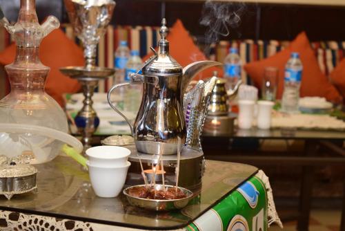 a tea kettle on a table with a bowl of food at Holidays Express Hotel in Cairo