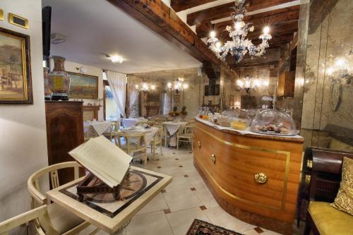 a restaurant with a bar with tables and chairs at Ca' Pagan in Venice