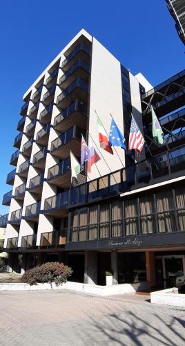 a building with many flags on the side of it at Residence all'Adige in Verona