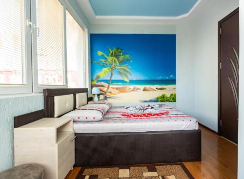 a bedroom with a bed with a beach view at Квартира у приморского парка in Batumi